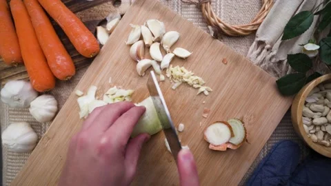 Slowmotion of chopping onion with cozy table background Stock Footage 185822905