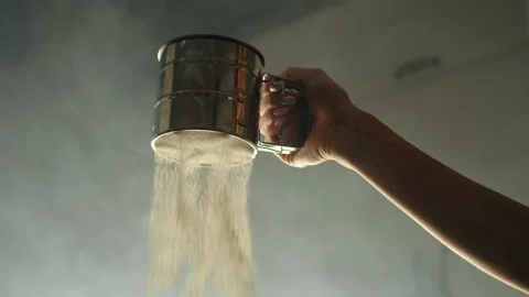 Slowmotion, close-up of flour sifting with sifter Stock Footage 236958389