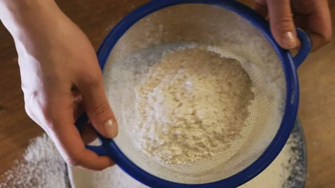 Slowmotion. Close-up of flour through a sieve fray. Sifting flour. Baking Stock Footage 105046689