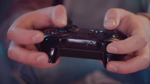 Slowmotion close-up of a game console in the hands of a gamer Stock-Footage 82277031