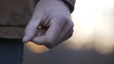 Slowmotion close-up hands of man at sunset Stock Footage 107321474