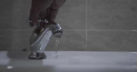 Slowmotion Close up of a man's hand opening the sink Stock Footage 285899304