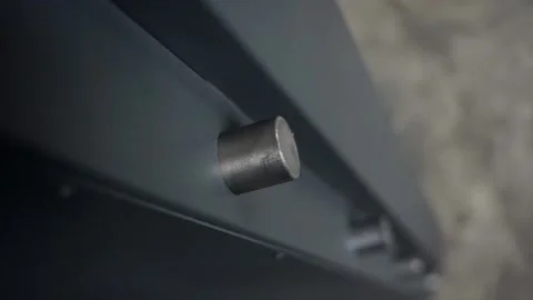 Slowmotion. Close up. Side view. The bolt slides out of the large metal door. Stock Footage 196879545