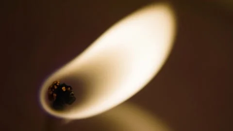 Slowmotion Closeup of a candlelight burning with melted wax around. Stock Footage 130284510