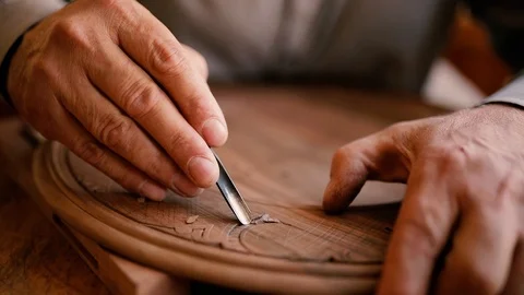 Slowmotion closeup shot of a master craftsman doing traditional wood carving Stock Footage 124692149