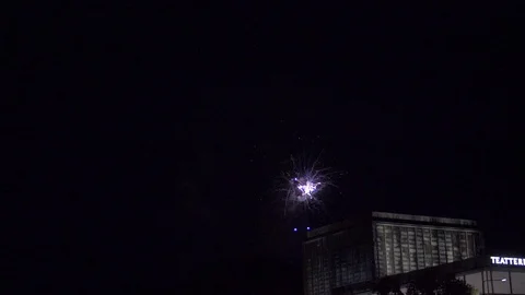 Slowmotion of colorful fireworks exploding in the nightsky above city Stock Footage 96181169