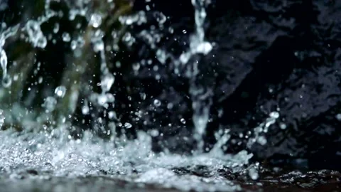 Slowmotion Drops of Water Falling in Puddle Stock Footage 135544400