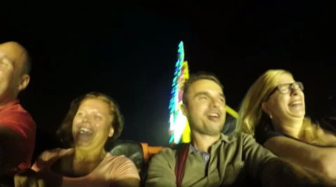 Slowmotion of ecstatic happy people on the roller coaster ride in amusement park 動画素材 66689592