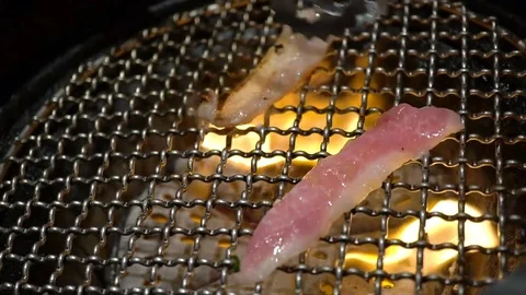Slowmotion flipping pork grill on flame yakiniku style Stock Footage