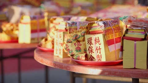 Slowmotion hands gently arranging red and yellow ritual papers on altar temple Stock Footage 312278407