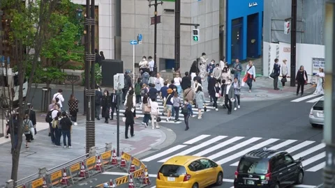Slowmotion looking down from above, a busy people hurry across the intersection. Stock Footage 308879436