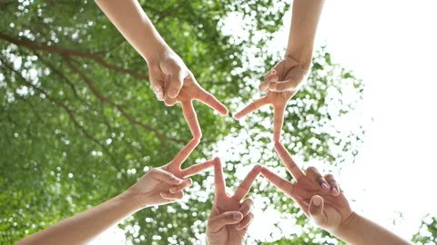 Slowmotion of low angle shot from below of a group of 5 people place their hands Video stock 134708611