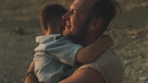 A slowmotion of a man hugging his son while holding him Vídeo Stock 122429089