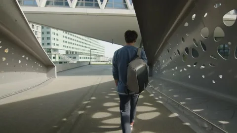 Slowmotion man walking to school with backpack Stock Footage 168991031