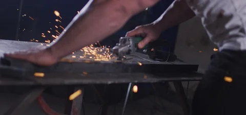 Slowmotion Man welding indoors with tools used in constuction fabrication.Redcam Stock Footage