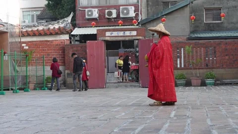 Slowmotion of monk walking through temple courtyard during mantra meditation Stock Footage 313628428