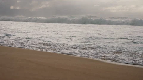 Slowmotion Pan from Beach with Huge Waves in the Background 4K Stock Footage 267048629