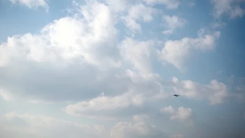 Slowmotion. Passenger airplane gaining height in the blue cloudy sky Stock Footage 104872357