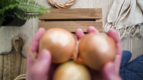 Slowmotion putting onions down with cozy table background Stock Footage 185822112