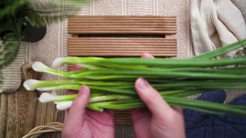 Slowmotion of putting spring onion on cozy table background Stock Footage 185821962