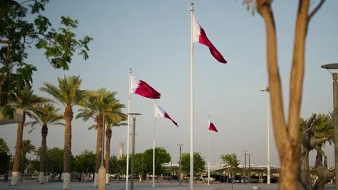Slowmotion of qatar flags infront of stadium Lusail Multipurpose Hall Stock Footage 305257511