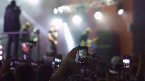 Slowmotion shot of a concert. People shoot videos on their cell phones. Stock Footage