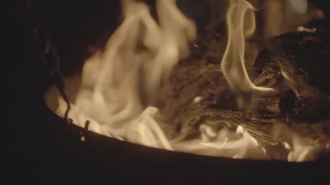 Slowmotion shot of a fire and flames burning away a newspaper in a fire pit Stock Footage 304150763