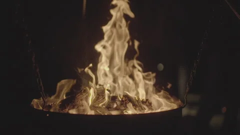 Slowmotion shot of a fire and flames burning away a newspaper in a fire pit Stock Footage 304321607