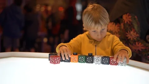 Slowmotion shot of a little boy visiting a science museum for children. He plays Stock Footage 102487986