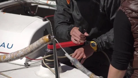 Slowmotion shot of a man using a yachting winch on a sailing boat Stock Footage