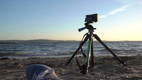 Slowmotion shot of waves at the beach with tripod in foreground Stock Footage 137425736