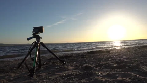 Slowmotion shot of waves at the beach with tripod in foreground Stock Footage 137425743