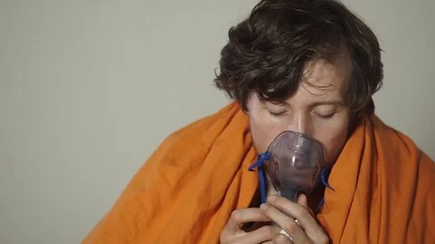 Slowmotion shot of a young man that cures sickness using ultrasonic inhalation. Stock Footage