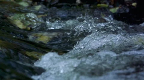 Slowmotion water of river flows across the stones Stock Footage 60071174