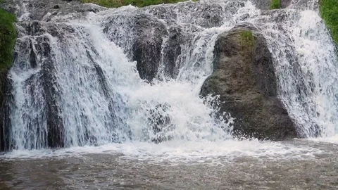 Slowmotion Waterfall Closeup Through Big Rocks Stock Footage 77531249