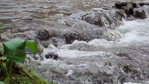Slowmotion Waterfall Closeup Through Big Rocks Stock Footage 77533147