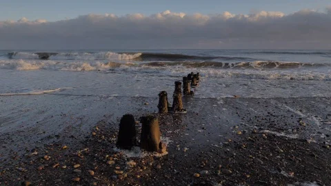 Slowmotion waves on groynes Stock Footage 99094286
