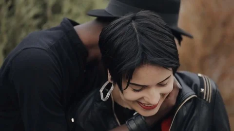 Slowmotion of white woman kiss black man cheek. Couple smiling together. Stock Footage