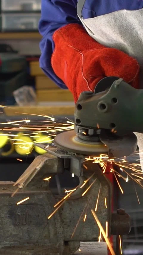 Slowmotion worker in special clothes and gloves grinding metal with circular saw Stock Footage 316077654