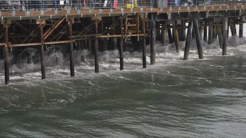 Sloww motion of wave hits a Santa Monica pier Stock Footage 263298123