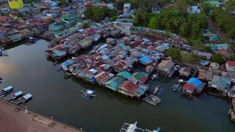 Slum Coron Palawan stilt houses built settlement over water. Smooth aerial view Stock Footage 340789853