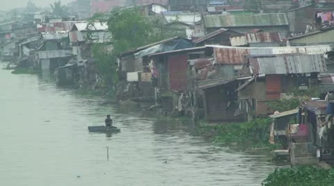 Slum Houses Line Bank Of Manila River Stock Footage