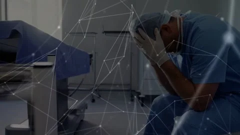 Slumping scrubbed surgeon, after surgery, burying face at operating table, Stock Footage 333965611
