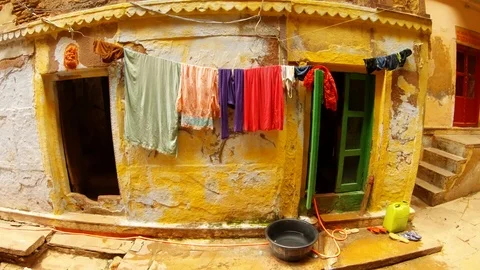Slums of Benares things dry over tacky enterance to house Stock Footage 99007340