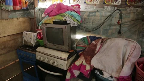 Slums on the water. inside the slums, an old TV and a gas stove. Stock-Footage 233288663