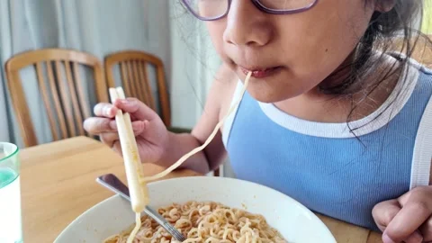 Slurping single noodle strand Stock Footage 328995232
