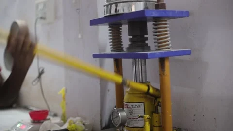Slurry hardness checking in the manual pressure machine in the lab Stock Footage 306237168