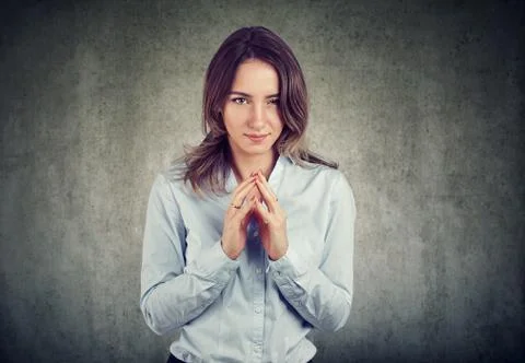Sly, scheming woman plotting something, thinking looking at camera Stock Photos
