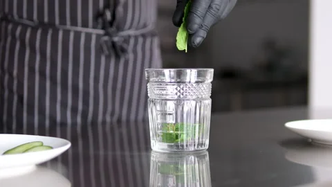 Smack mint with hand. Add mint to glass. Making lemonade, summer drink, cold Stock Footage 278577363