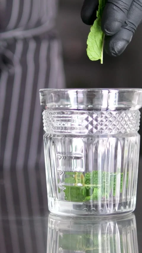 Smack mint with hand. Add mint to glass. Making lemonade, summer drink, cold Stock Footage 278578094